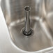 An Eagle Group stainless steel underbar sink with a metal pipe over it.