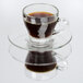 A Libbey glass cappuccino saucer with a glass cup of coffee on it.
