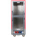 A red and silver metal Metro holding and proofing cabinet with clear Dutch doors.