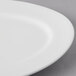 A white Libbey Aluma white porcelain platter with a thin rim.