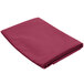 A folded mauve table cover on a white background.