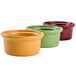 A close up of three Tuxton casserole dishes in assorted colors.