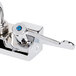 A chrome Equip by T&S wall mount swivel faucet with blue wrist action levers.