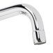 A chrome Equip by T&S wall mount faucet with curved wrist action handles.