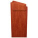 An Oklahoma Sound Aristocrat floor lectern in wild cherry wood with a handle.