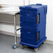 A navy blue Cambro Ultra Camcart food pan carrier on wheels.