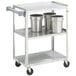 A Vollrath stainless steel utility cart with three shelves holding silver containers.