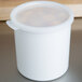 A white Cambro round crock lid on a white container.
