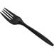 A pack of black plastic forks with a white background.