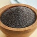 A bowl of Regal bulk poppy seeds on a table in a store.
