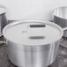 A Vollrath Wear-Ever aluminum pot cover on a stainless steel pot.