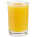 A Libbey side water/tasting glass filled with orange juice on a white background.
