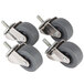 A set of four Manitowoc stem casters with grey rubber wheels.