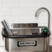 A stainless steel Nemco dipper well with a black handle.