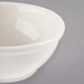 A close-up of a Libbey ivory porcelain oatmeal bowl with a white rim.