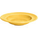 A yellow Tuxton Concentrix china bowl with ripples in the surface.