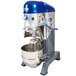 A blue and silver Vollrath floor mixer with a blue bowl in it.