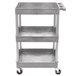 A gray plastic Luxor utility cart with three shelves and wheels.