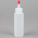 A white plastic Tablecraft squeeze bottle with a red cap.