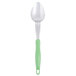 A Vollrath Jacob's Pride heavy-duty basting spoon with a green Ergo grip handle.
