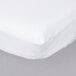 A close up of a white fitted crib sheet on a bed.