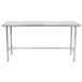 A stainless steel Advance Tabco work table with a metal frame and legs.