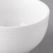 A close-up of a white Reserve by Libbey Aluma White Porcelain Bouillon Cup with a rim.
