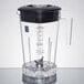 A Waring clear blender jar with a black lid.