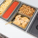 A tray of food in a Cambro amber plastic food pan on a counter.