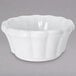 A white bowl with a scalloped edge.