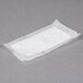 A white tissue in a plastic wrapper.