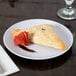 A pastry with a strawberry on a GET White Siciliano plate.