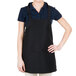 A woman wearing a Chef Revival black apron with 3 pockets.