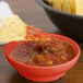 A Rio orange melamine salsa bowl with chips and salsa on a table.