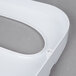 A white plastic Thunder Group toilet seat cover dispenser.