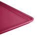 A close-up of a large rectangular cherry red Cambro dietary tray.