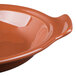 A Libbey terracotta handled baker with a brown rim.