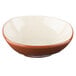 A close up of a Libbey Terracotta bowl with a white base and a brown rim.