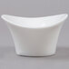 An Arcoroc white porcelain deep oval bowl with a curved edge.