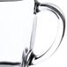 A clear glass Libbey square warm beverage mug with a handle.