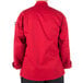 The back of a person wearing a Mercer Culinary red cook jacket with long sleeves.