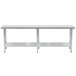 A long silver Advance Tabco stainless steel work table with metal legs and a galvanized undershelf.