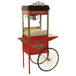 A red and white Benchmark USA popcorn cart with wheels.