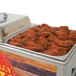 A Benchmark USA countertop chicken wing warmer holding a tray of chicken wings.