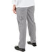 A person wearing Mercer Culinary Genesis women's houndstooth cargo pants with their hands in their pockets.
