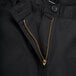 A close up of the zipper on Mercer Culinary black chef trousers.
