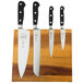 A Mercer Culinary Renaissance knife set on a wooden magnetic knife board.