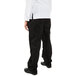 The back of a person wearing Mercer Culinary Genesis Women's Black Cargo Pants over a white shirt.