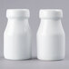 Two white ceramic milk bottle-shaped salt and pepper shakers.