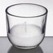 A Sterno clear glass wax filled candle with a white candle inside.